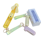 Colorful mini fans with keychains and a box on a white background